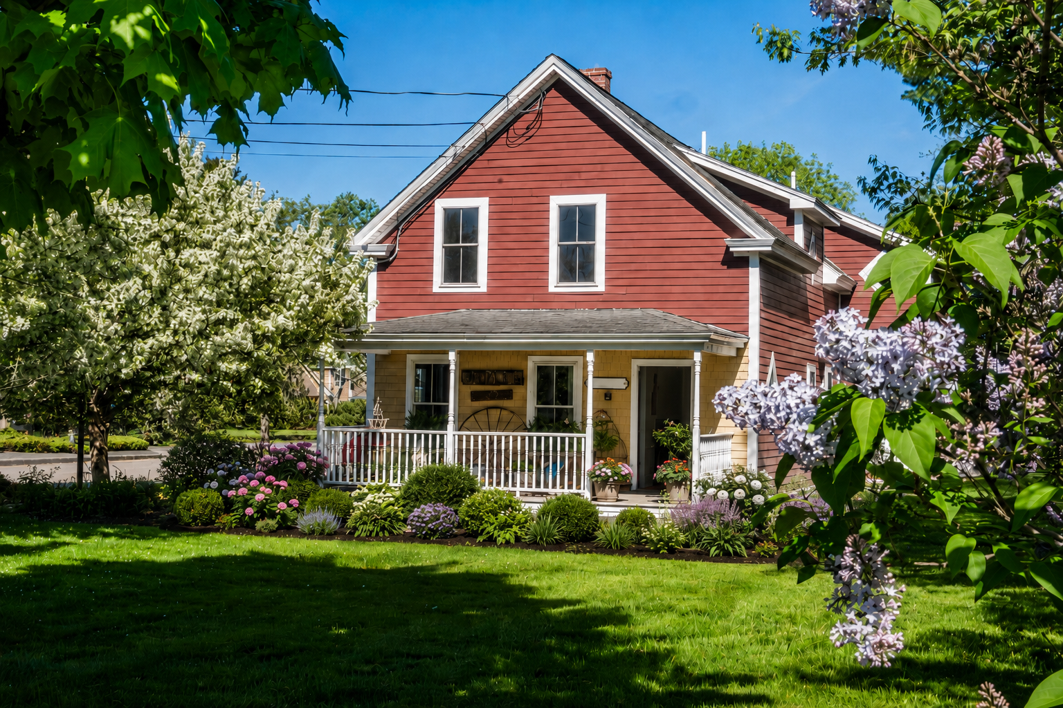 The Dovetail Shop exterior in spring with flowering trees and a front porch.