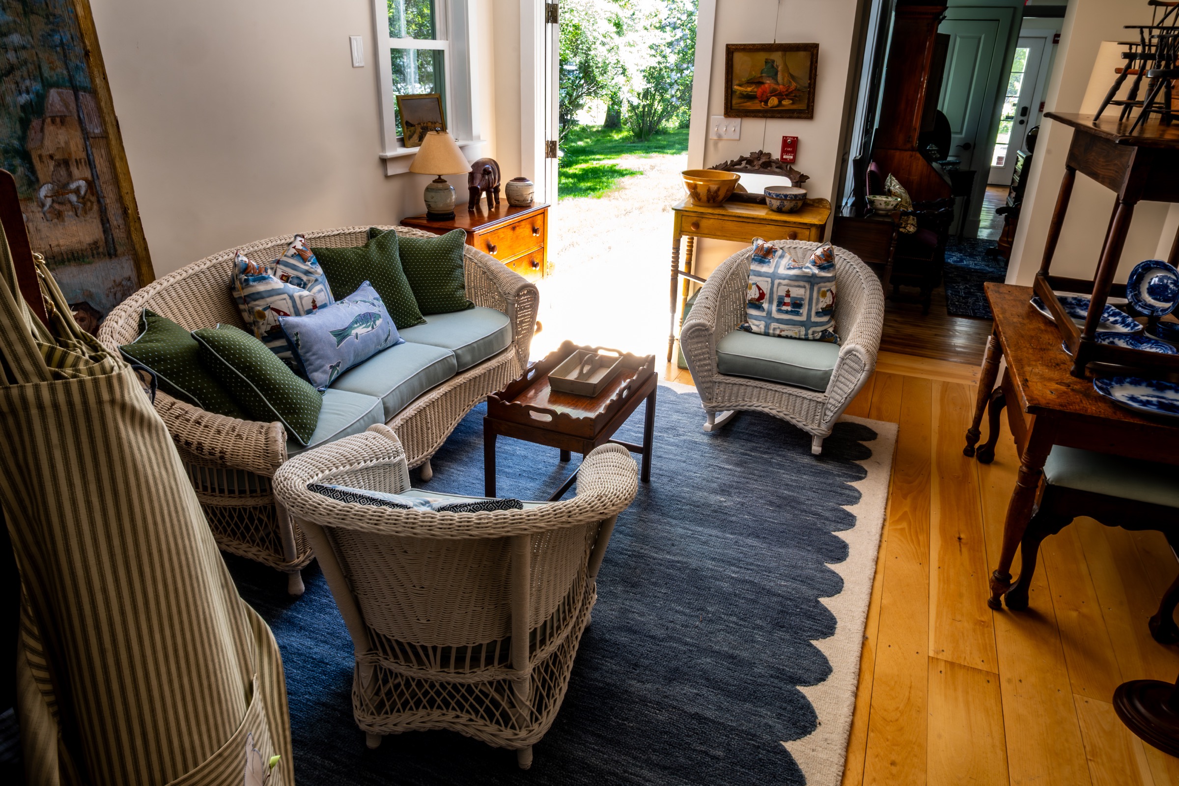 Wicker seating area and antique furniture inside the shop.
